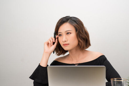 Asian girl graphic designer thinking idea for a new project, freelancer thinking idea for a new project in selective focus.