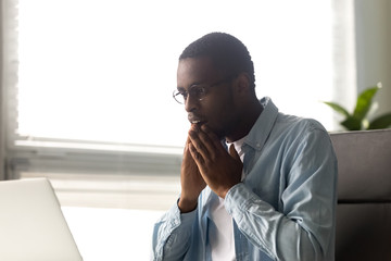 Amazed African employee read news seated at desk © fizkes