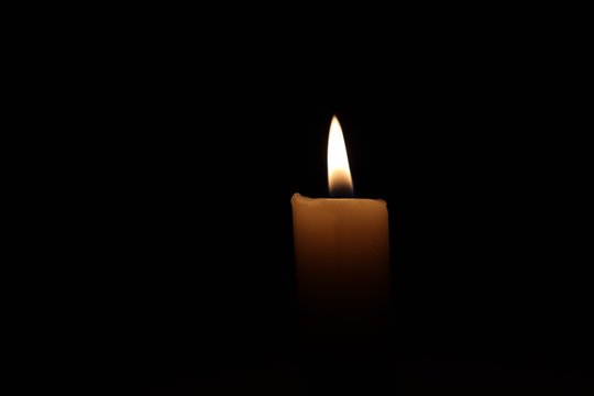 Candle black background of mourning funeral  moment of silence
