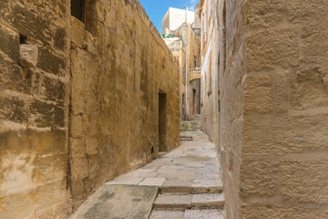 Ancient narrow empty street in historical center of Birgu or Vittoriosa, Malta
