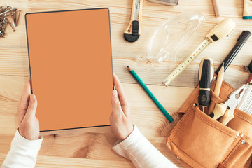 Female carpenter using digital tablet computer, mock up screen