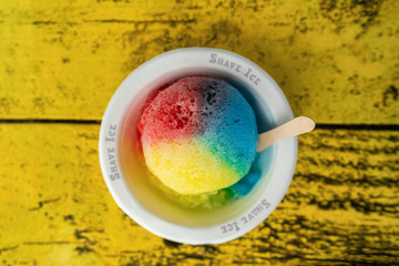 Shave Ice Hawaii local food hawaiian snow cone with three colors colored dyes. Frozen dessert food...