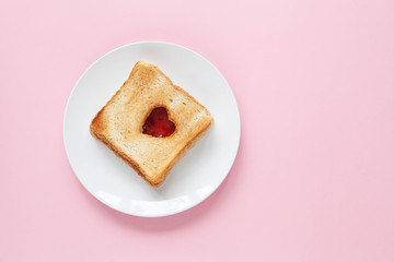 Heart toast with jam on a white plate. Valentine day concept