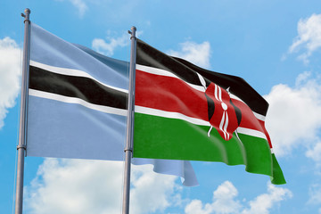 Kenya and Botswana flags waving in the wind against white cloudy blue sky together. Diplomacy concept, international relations.