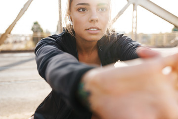 Obraz premium Sports fitness woman make stretching exercises outdoors.