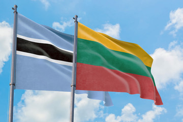 Lithuania and Botswana flags waving in the wind against white cloudy blue sky together. Diplomacy concept, international relations.