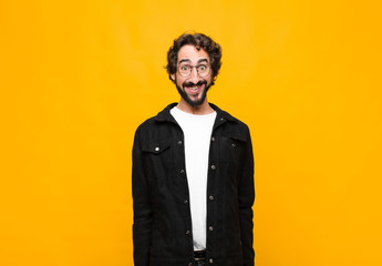 young crazy handsome man looking happy and goofy with a broad, fun, loony smile and eyes wide open...
