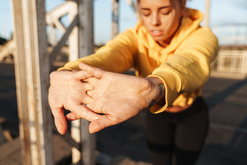 Sports fitness woman make stretching exercises outdoors.