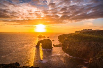 Dramatic sky at sunset with Enys Dodnan and the Armed Knight rock formations at Lands End