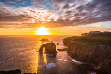 Dramatic sky at sunset with Enys Dodnan and the Armed Knight rock formations at Lands End,...