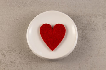 red heart symbol on a white background. view from above. in the center. Romance and valentines day concept.
