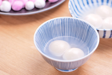 Delicious tang yuan, yuanxiao in a small bowl. Traditional festive food rice dumplings ball with stuffed fillings for Chinese Lantern Festival, close up.