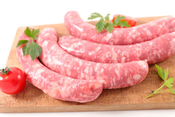 raw sausage on wooden board