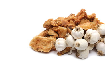 Pork cracklings, greaves with garlic cloves isolated on white background