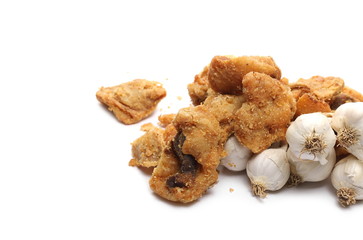 Pork cracklings, greaves with garlic cloves isolated on white background