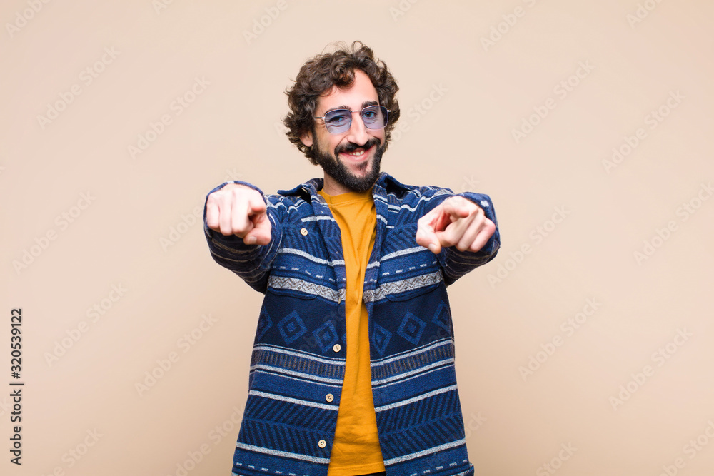 Poster young crazy cool man feeling happy and confident, pointing to camera with both hands and laughing, c