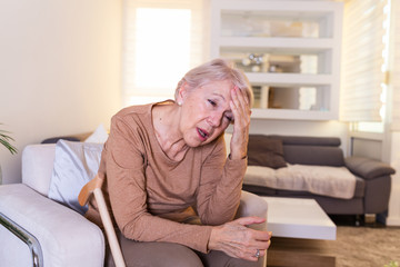 Attack of the monster migraine. Sinus pain. Unhappy Retired Senior Woman holding her head with pain...