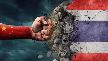 Fist breaking rock. China destroying Thailand
