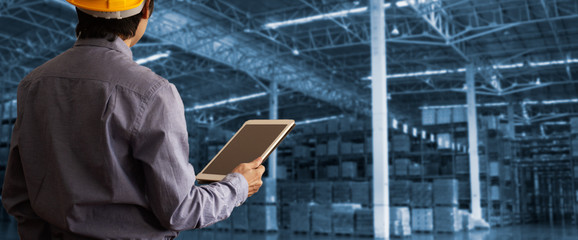 Worker using tablet check and control for workers with Modern Trade warehouse logistics