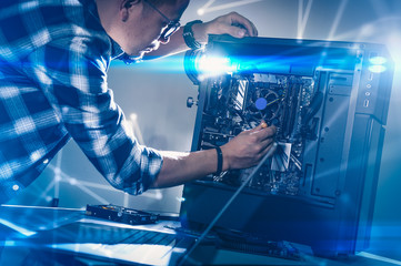 The technician hold the screwdriver for repairing the computer. the concept of computer hardware, repairing, upgrade and technology.