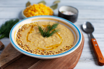 Corn soup in bowl and sweet corn on plate