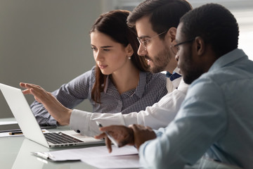 Team leader showing to interns corporate program during group meeting