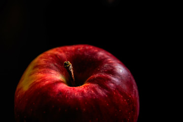 Delicious red apple isolated on black background