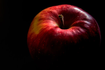 Delicious red apple isolated on black background