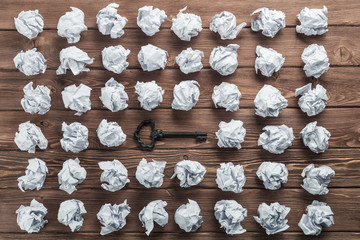 Concept of success and opportunity with old key among paperballs