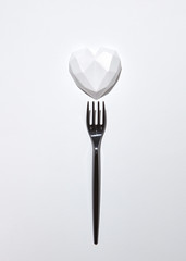 Black plaster fork with gypsum white heart .