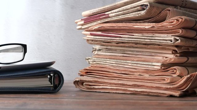 Close up of stack of newspaper on table 