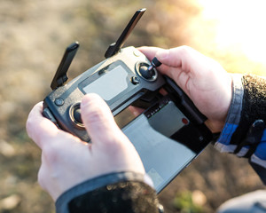 Man Operating drone remote controller.