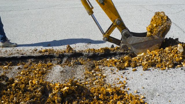 Mini excavator with narrow bucket for laying fiber-optic cable line