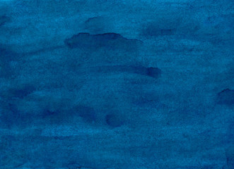 Watercolor azure blue background texture, stains on paper. Hand painted dark blue rough watercolour backdrop.