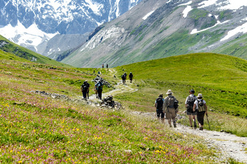 Fototapeta na wymiar Elderly tourists walking in the mountains of the French Alps.