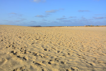Natural background, a vast sandy beach with a clear horizon at sunset on Sal Island in Cape Verde, Cabo Verde
