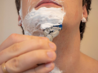 Daily male shaving procedure. Shaving with a razor.