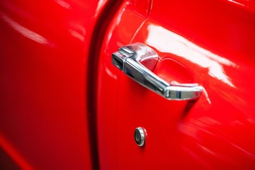 chrome door handle on red classic car