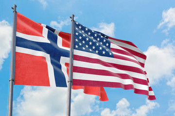 United States and Bouvet Islands flags waving in the wind against white cloudy blue sky together. Diplomacy concept, international relations.