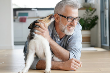 Man with puppy dog at home