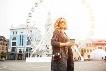 Young blonde girl and a ferris wheel