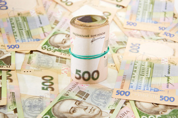 twisted 500 hryvnias against a hryvnias background.