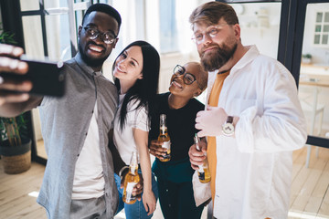 Multiethnic cheerful company taking selfie