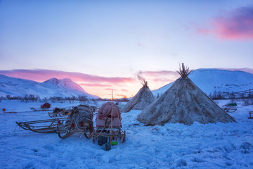 Nenets reindeer herders choom on a winter sunset
