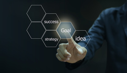 Businessman pressing  button on virtual touch screen on blue technology background