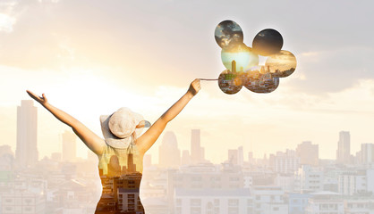 Double exposure of free woman silhouette and modern city skyline.