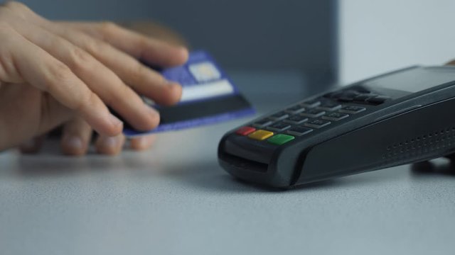 Payment by credit card, purchase and sale of goods and services. Credit card in the store. girl lifestyle pays the card reader online shopping concept