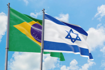 Israel and Brazil flags waving in the wind against white cloudy blue sky together. Diplomacy concept, international relations.