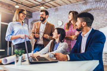 Young team of coworkers making great meeting discussion in modern coworking office.