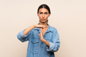 Young woman over isolated background making time out gesture